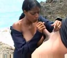 A busty young Latina sucks dick at the beach 