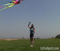 Little April sucking on a rainbow popsicle